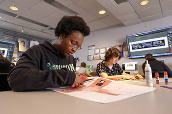 A student works in a graphic visual design class