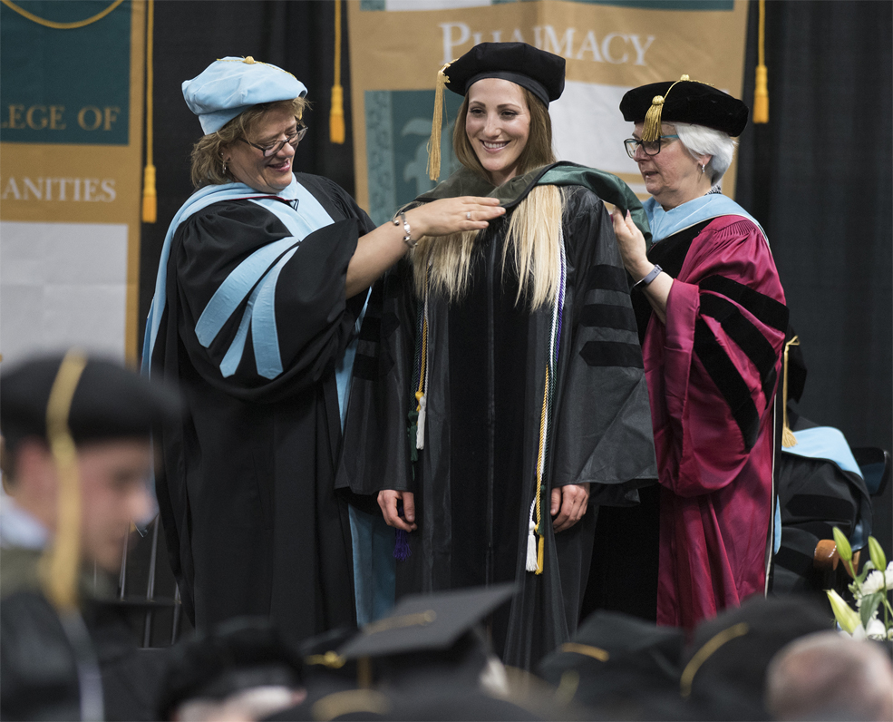 Graduate students being hooded during commencement exercises