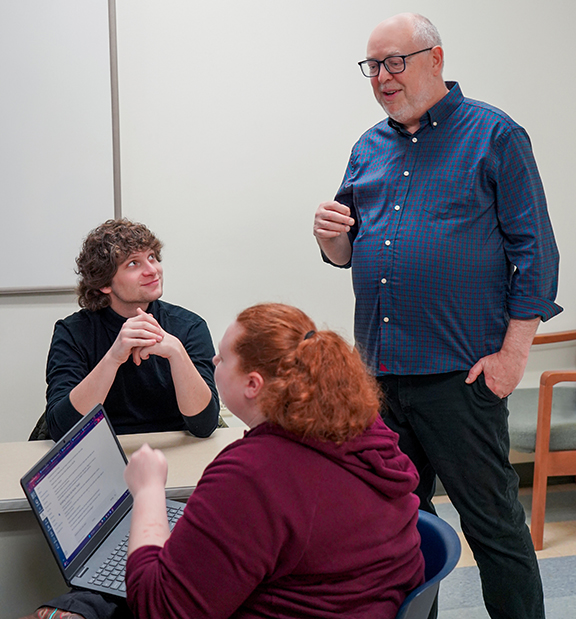 Dr Clifton Guthrie works with students in a classroom