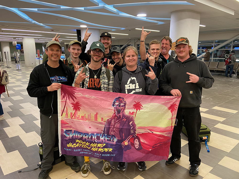 Students hold a banner for the annual ShipRocked cruise 