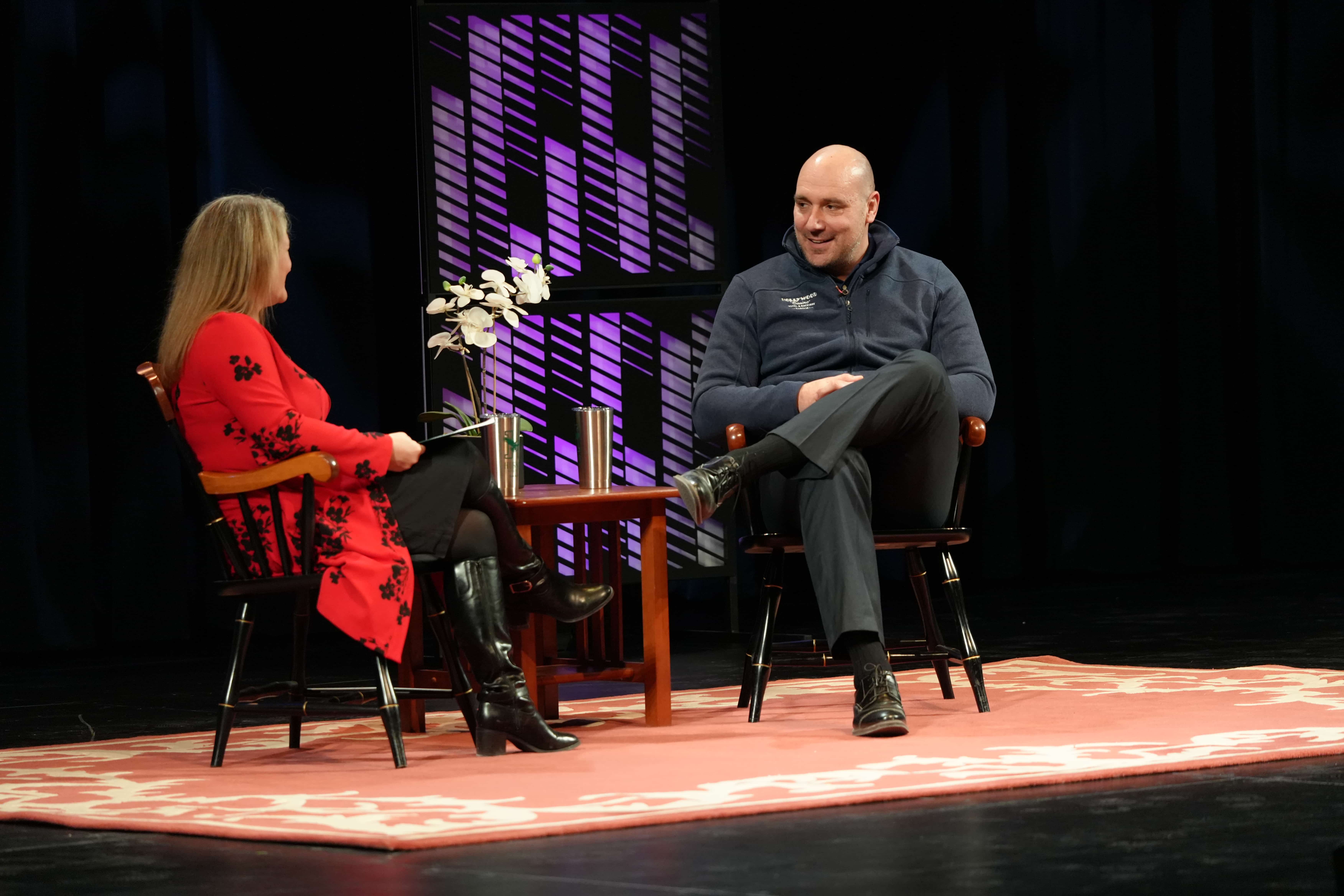 Marc Guastella and Marie Hanson talk on stage during the Distinguished Business Speaker Series event.