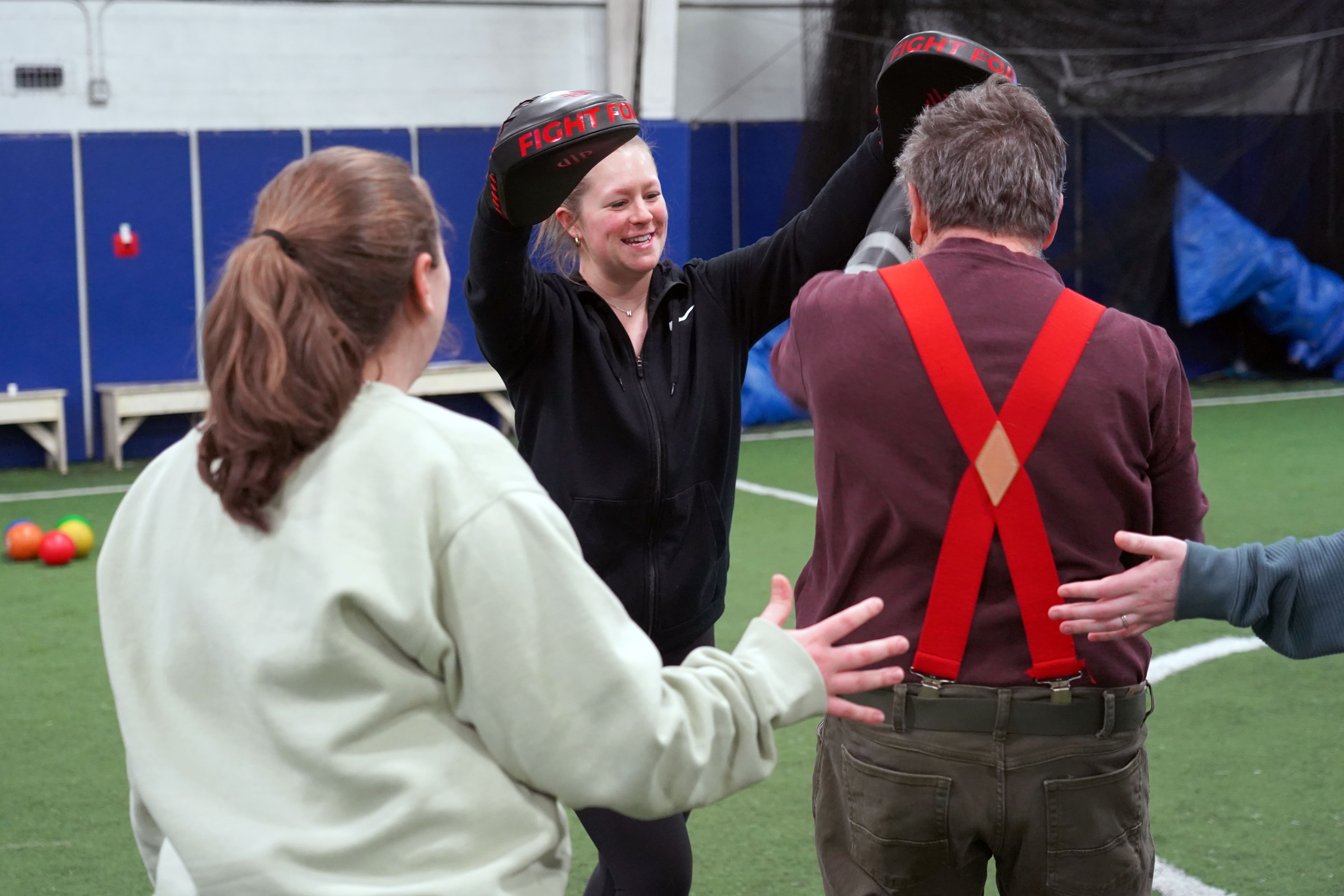 Husson student does boxing drill with individual.