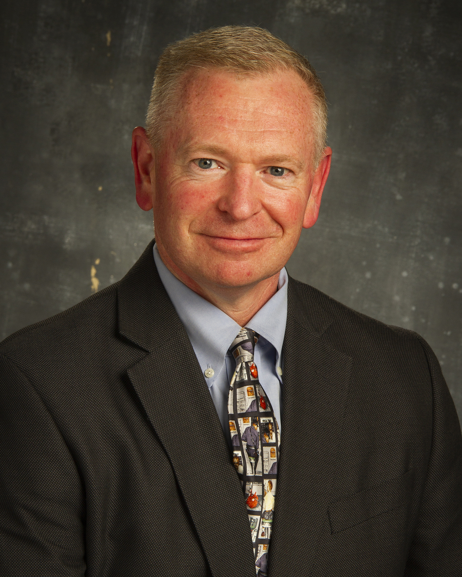 A headshot of a man is shown.