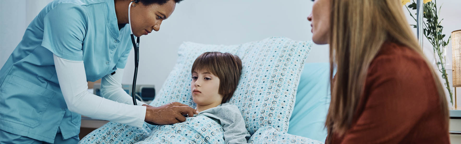 A nurse works with a mother and child