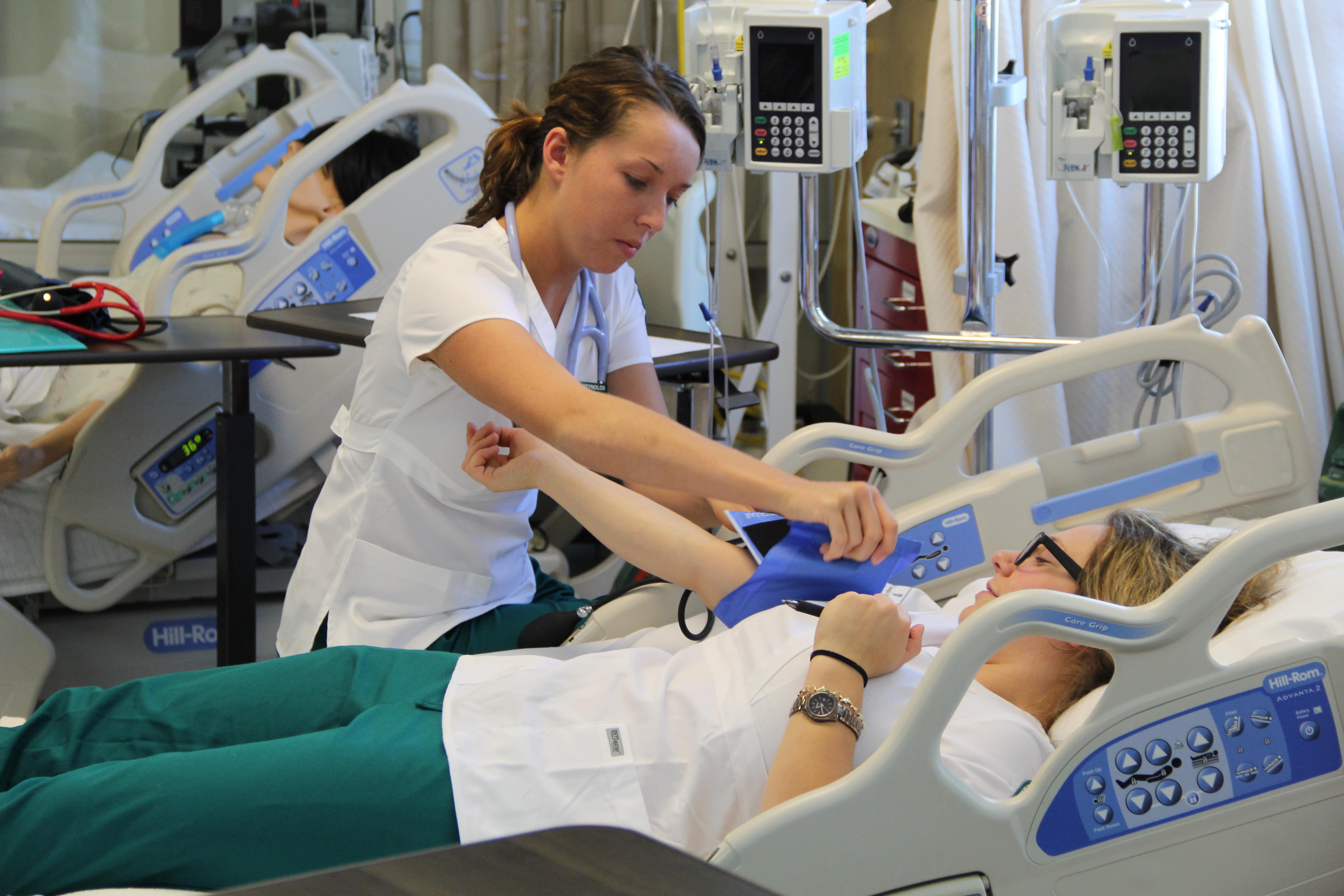 nursing student attending to patient