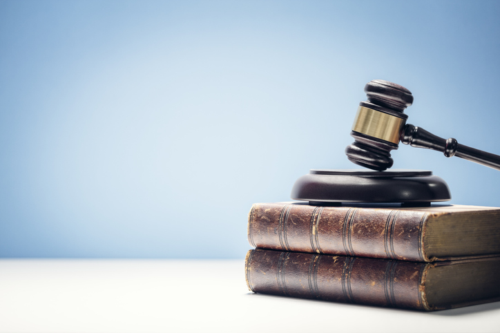 A judge's gavel on a stack of books.