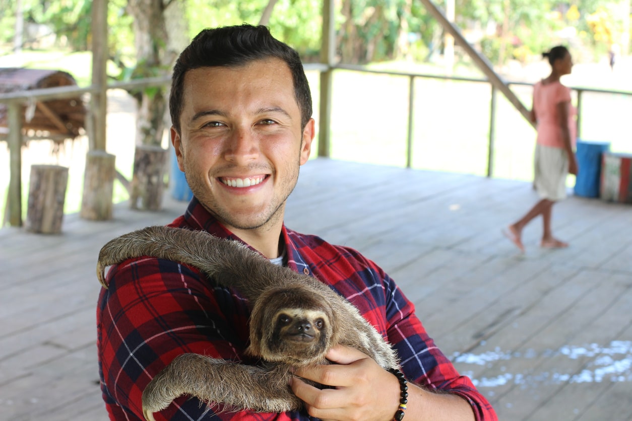 Wildlife rehabilitator caring for a sloth.
