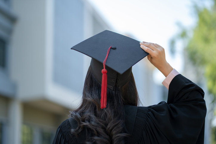 College graduate wearing their graduation cap.